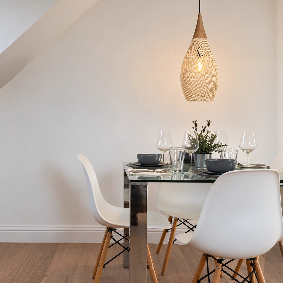 A narrower open shade gives an airy focal point above a pale table.