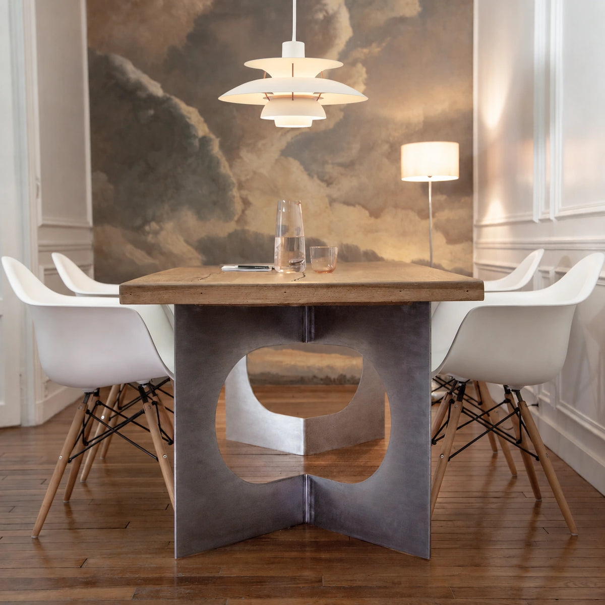 Layered Scandinavian Pendant Lamp in warm white above a wood dining table with white chairs