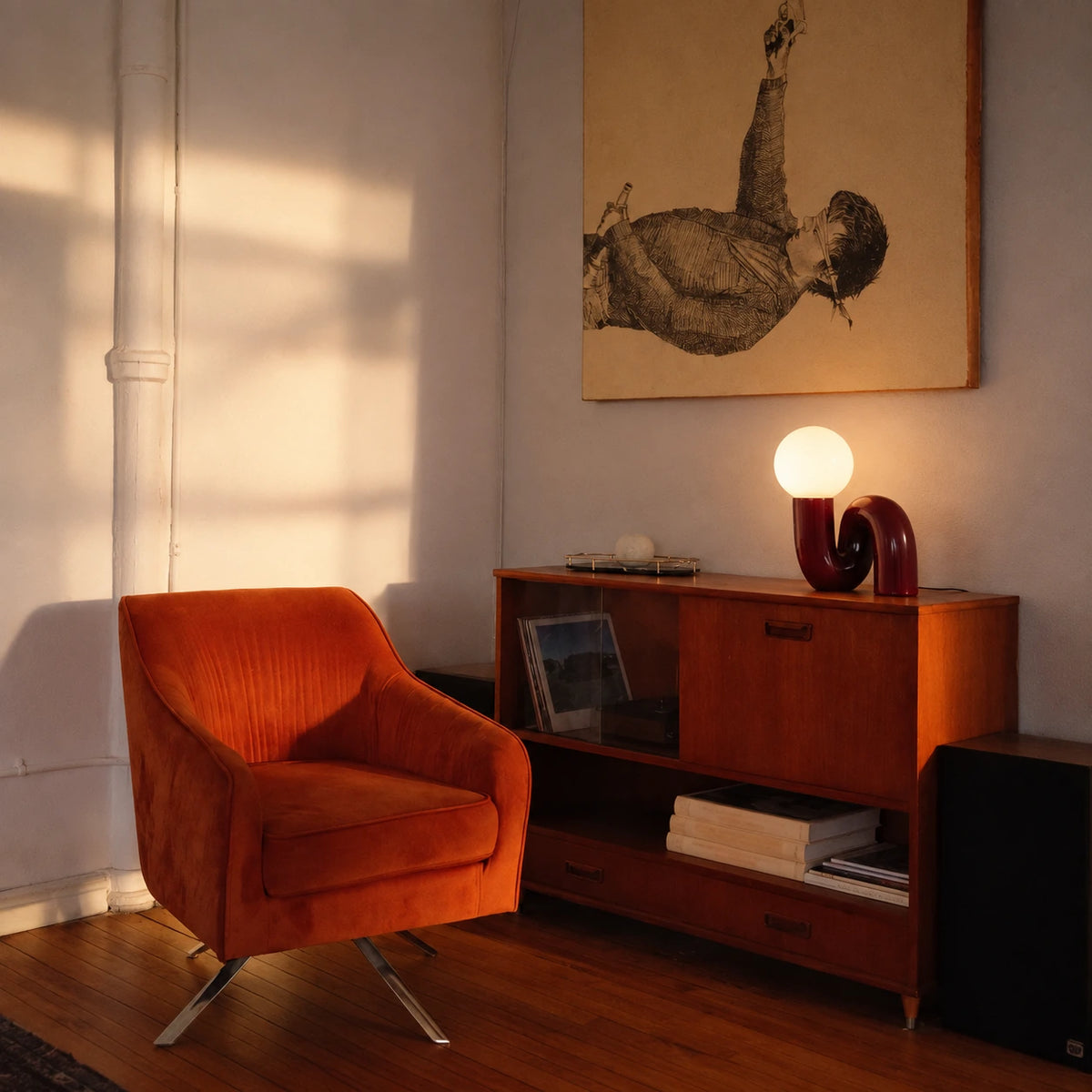 A burgundy loop lamp is a colour accent on a mid-century sideboard.