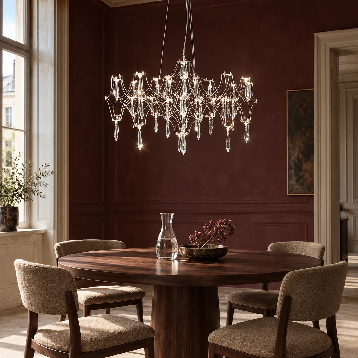 Silver branching crystal pendant above a round walnut dining table in a Vienna apartment