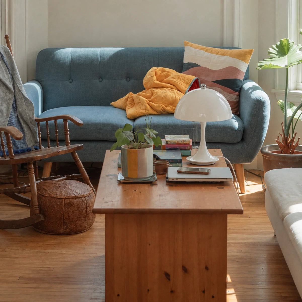 White Dome corded table lamp on a coffee table in a lived-in blue-sofa living room